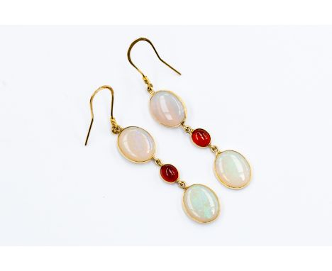 A pair of opal and garnet drop earrings, two oval opals optical set with a cabochon garnet set in between, 14 ct gold, length