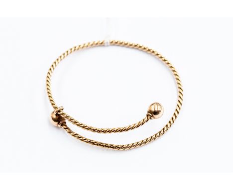 9ct gold slave bangle of sprung rope twist design, ball shaped terminals, weight approx 15.4gms 