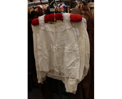 A cotton lawn white Edwardian blouse with lace insets and an embroidered leaf design with capped pearl buttons and turned bac