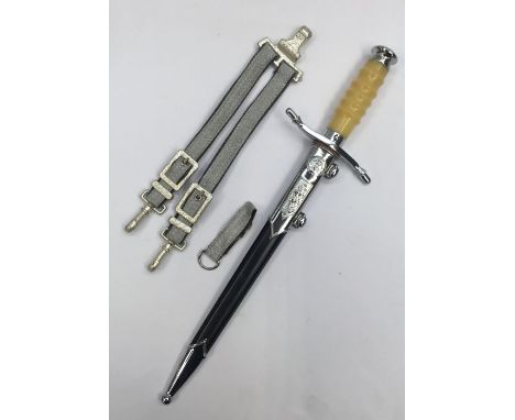 A post WW2 East German DDR officers dress dagger.Chromed fittings with a pebbled pommel and yellow plastic grip.Complete with