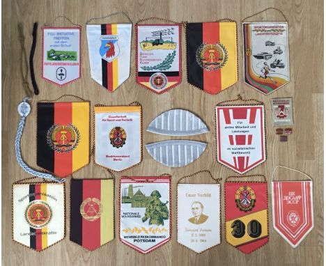 A selection of post war East German DDR, insignia and pennants.To include: a pair of matched musician wings ‘swallows nests’ 