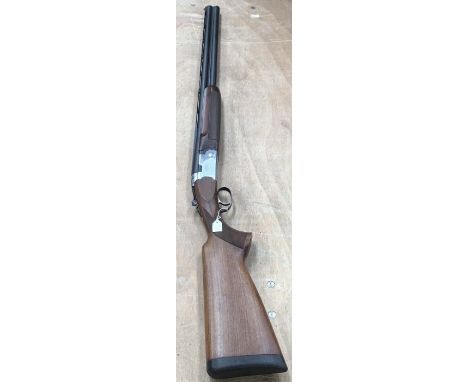 A 12b Beretta over and under shotgun, number L85134B with Firearm travelling security hard case. 34” barrel compartment and a