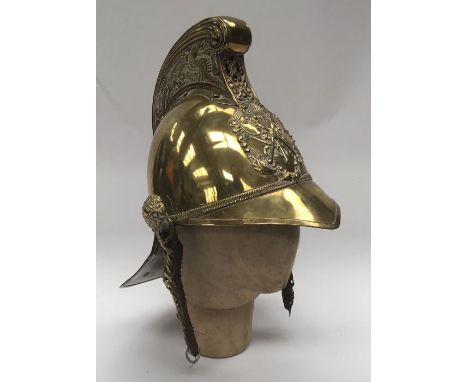 A late 19th / early 20th century brass fireman’s helmet by Merryweather & Sons of London.Standard pattern with raised comb to