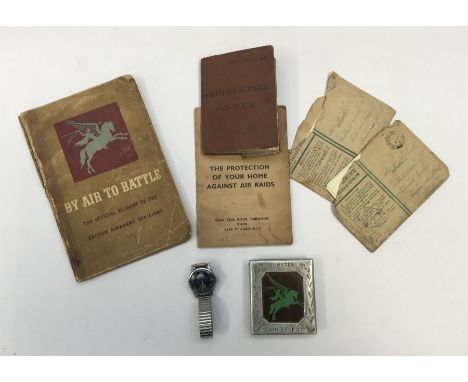 A WW2 German military wristwatch by Helios, together with a hand made aluminium cigarette case, fitted with a parachute regim