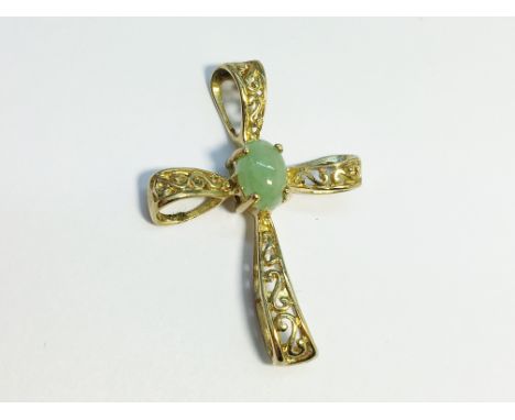 A 9ct gold cross set central jade stone.