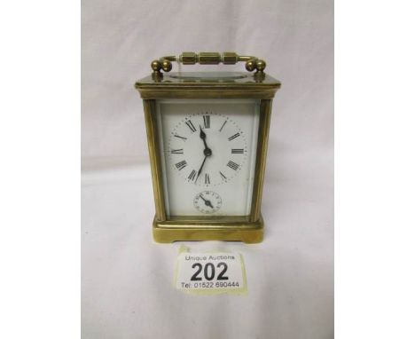 A French brass carriage clock with key.