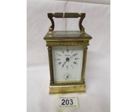 A brass 'Angelus' carriage alarm clock with key.