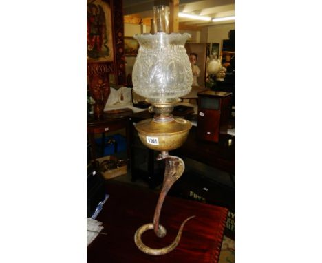 A brass oil lamp in the form of a cobra snake