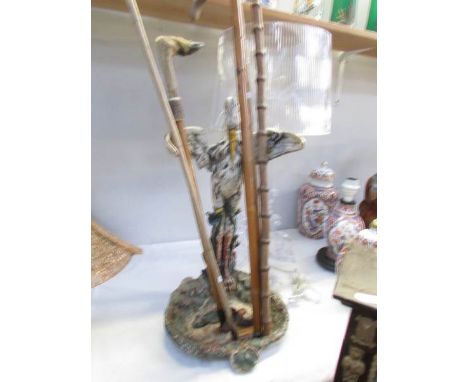 A cast metal stick stand with sticks.