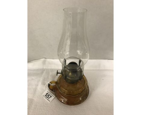 An amber glass hand oil lamp.