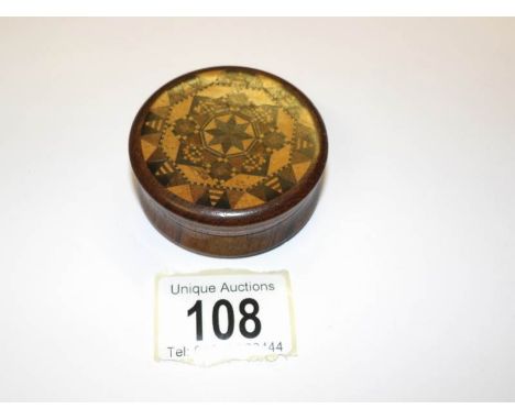 A screw top Tunbridge ware snuff box with original maker's label inside.