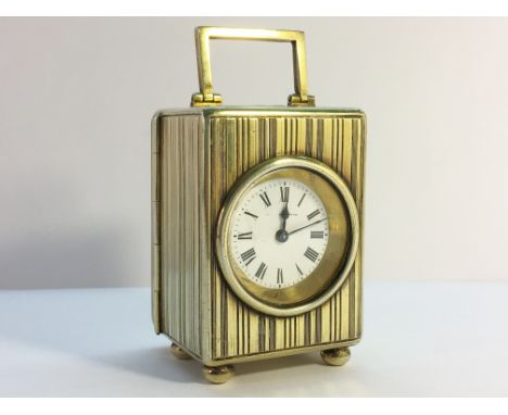 A small silver gilt carriage clock.