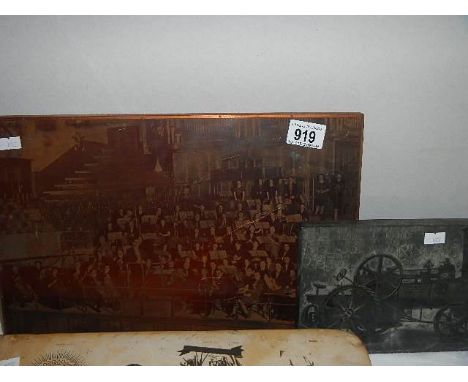A large copper plate printing block of an orchestra and a printing block of a steam engine.
