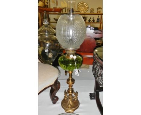 A rare medium sized Victorian oil lamp circa 1875. A round brass base standing on three small feet. The pedestal having three