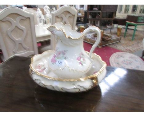 A jug and basin set with floral decoration.