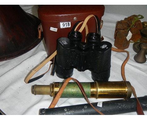 A pair of Carl Zeiss 10 x 50 binoculars, a brass telescope and one other item.