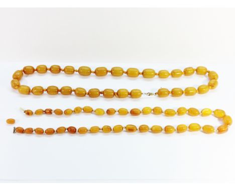 2 butterscotch amber necklaces. ~The first weighs 87 grams and measures 26" long with 30 olive shaped beads. The second weigh