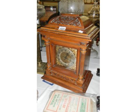 An oak bracket clock with key &amp; pendulum