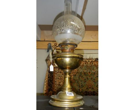 A brass oil lamp with shade &amp; chimney