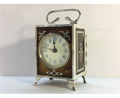 A silver and tortoise shell carriage clock (fine crack to tortoise shell front).