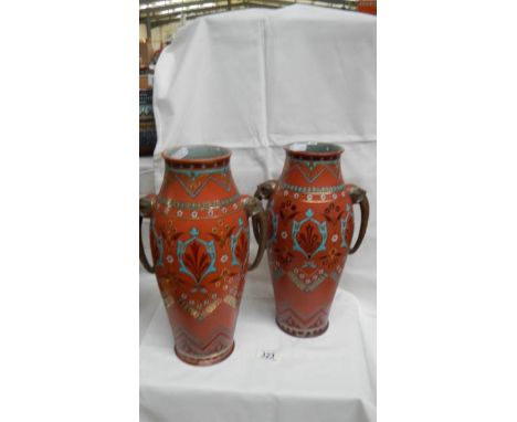 A pair of Mettlach vases,1870, with imprinted numbers '3' and '89' on the base on one and '88' and '36' on the other. Brick r
