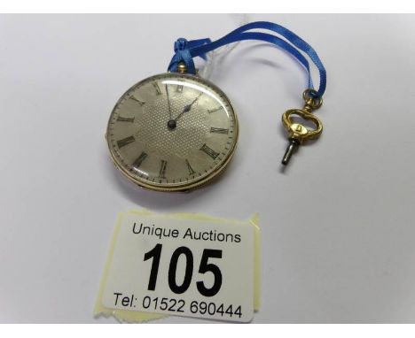 An 18ct gold and enamel pocket watch with key and in working order.