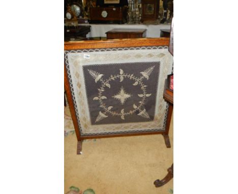 A large oak framed firescreen with lace &amp; gold/silver thread panel