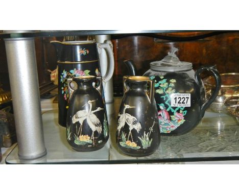 An oriental pattern teapot with pewter lids, an oriental pattern jug (chip on spout), and a pair of English stork decorated v