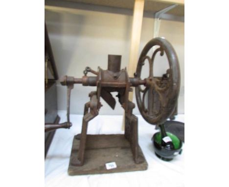 An old grinder/mincer on stand.