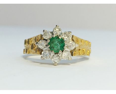 An 18ct yellow gold circular diamond ring with centre emerald, size K.