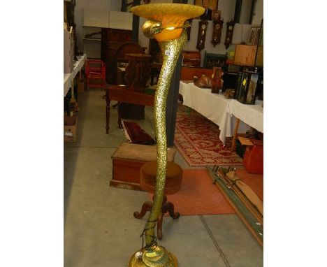 A modern gilded table lamp in the form of a snake.