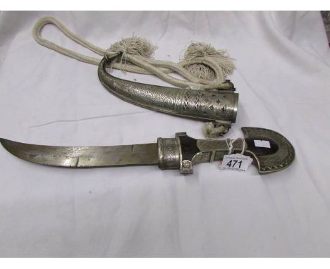 A middle eastern curved dagger in sheath.