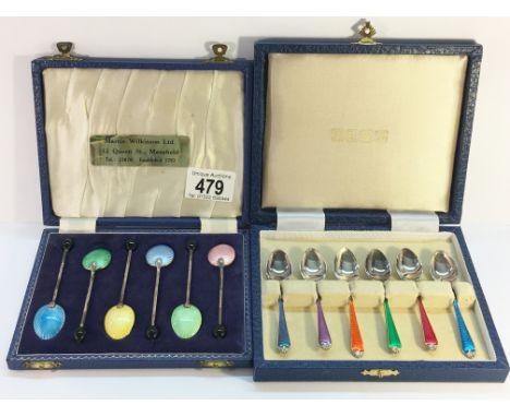 A cased set of 6 silver and enamel spoons together with a cased set of enamel spoons.