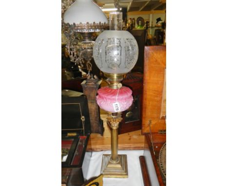 A Victorian parlour oil lamp, circa 1890.  With its beautiful pink-to-lighter-pink milk glass vessel sitting on a strong Cori