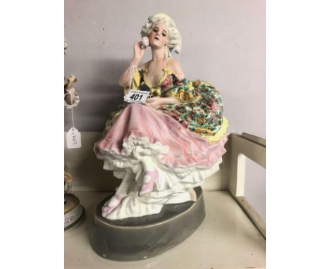 A superb Goldscheider figure of a lady in her boudoir. 37cm tall.