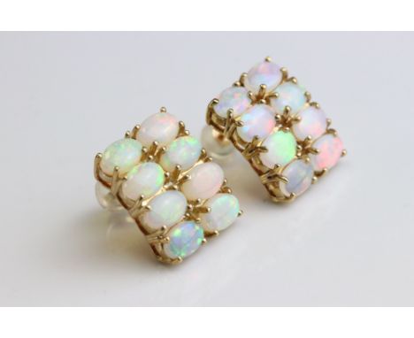 Pair of opal 9ct yellow gold stud earrings, each earring comprising eight oval cabochon cut precious white opals displaying v