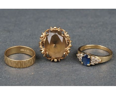 Three rings comprising smoky quartz 9ct yellow gold ring, openwork mount, ring size K; sapphire and diamond 9ct yellow gold d