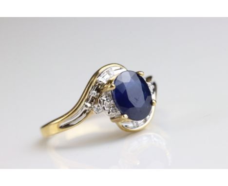 Blue sapphire and diamond 9ct yellow gold crossover ring, the oval blue sapphire measuring approx N½, four claw settings, six