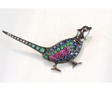 Sapphire, emerald, ruby and diamond unmarked yellow gold and silver brooch modelled as a pheasant, the body and tail full set