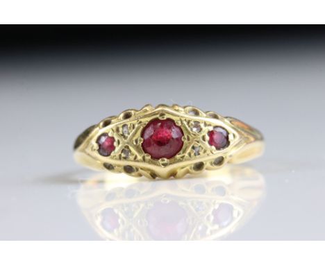 Early 20th century ruby yellow gold boat head ring, three graduated small round mixed cut rubies, four small rose cut diamond