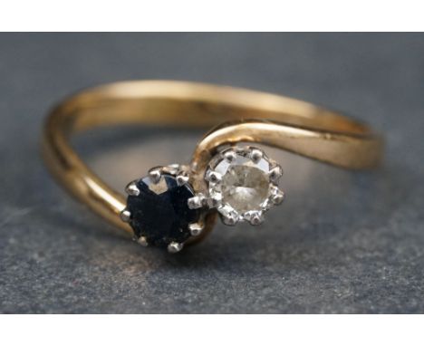 Diamond and sapphire 9ct yellow gold crossover ring, the round brilliant cut diamond weighing approx 0.33 carat, assessed col