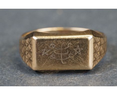 9ct yellow gold Gents signet ring, the rectangular panel engraved with stars and hoops, engraved stars to tapered shoulders, 