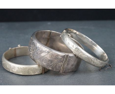 Silver hinged bangle, bright cut floral and foliate scroll decoration, width approx 2.5cm, tongue and box clasp with safety c