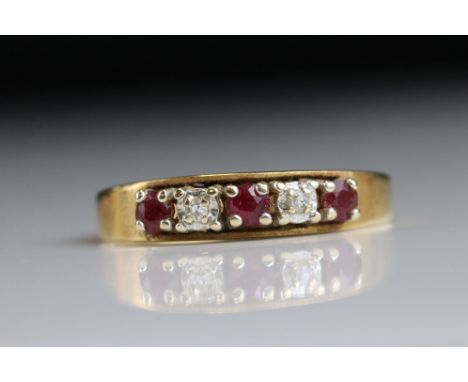 Ruby and diamond 18ct yellow gold five stone ring, three small round mixed cut rubies, claw settings and two small round eigh