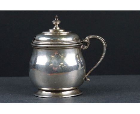 Silver mustard pot, oval bulbous footed form, scroll handle with acanthus leaf decoration, ogee finial to hinged lid, makers 