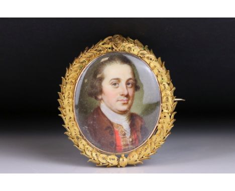 18th century hand painted portrait miniature brooch depicting a gentleman, mother-of-pearl plaque verso, yellow metal filigre