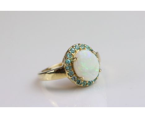 Opal and tourmaline 14ct yellow gold cluster ring, the precious white opal displaying yellow, green and orange play of colour