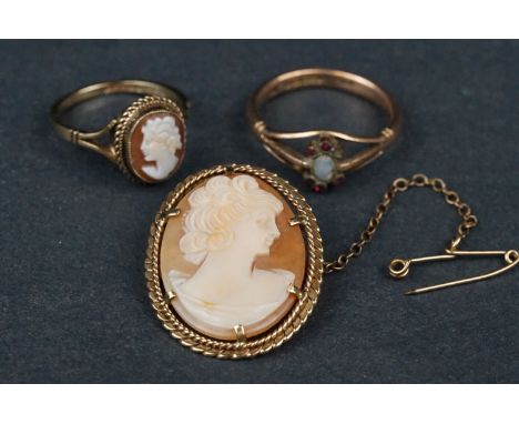 Shell cameo 9ct yellow gold ring, a shell cameo 9ct yellow gold brooch and an opal and ruby 9ct yellow gold ring (one ruby de