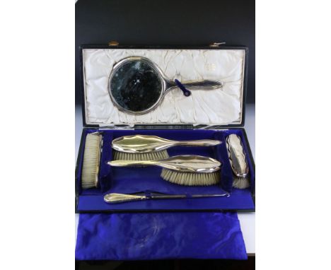 Early 20th century five piece silver backed dressing table set comprising two hair brushes, two clothes brushes and a hand mi