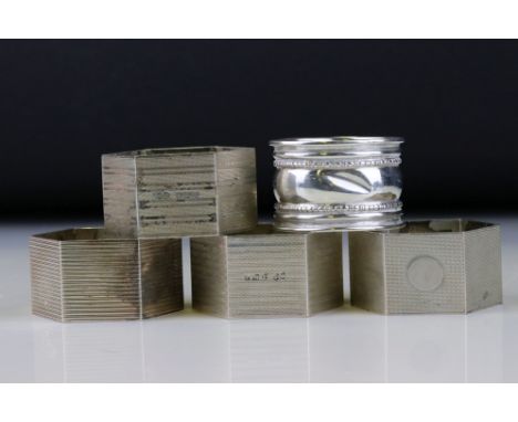 Four unmatched hexagonal silver napkin rings, engine turned decoration, makers E S &amp; Co, Birmingham 1950 together with a 